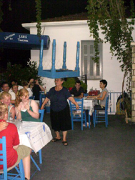 old lady dancing with table on head in Spartahori, Meganisi